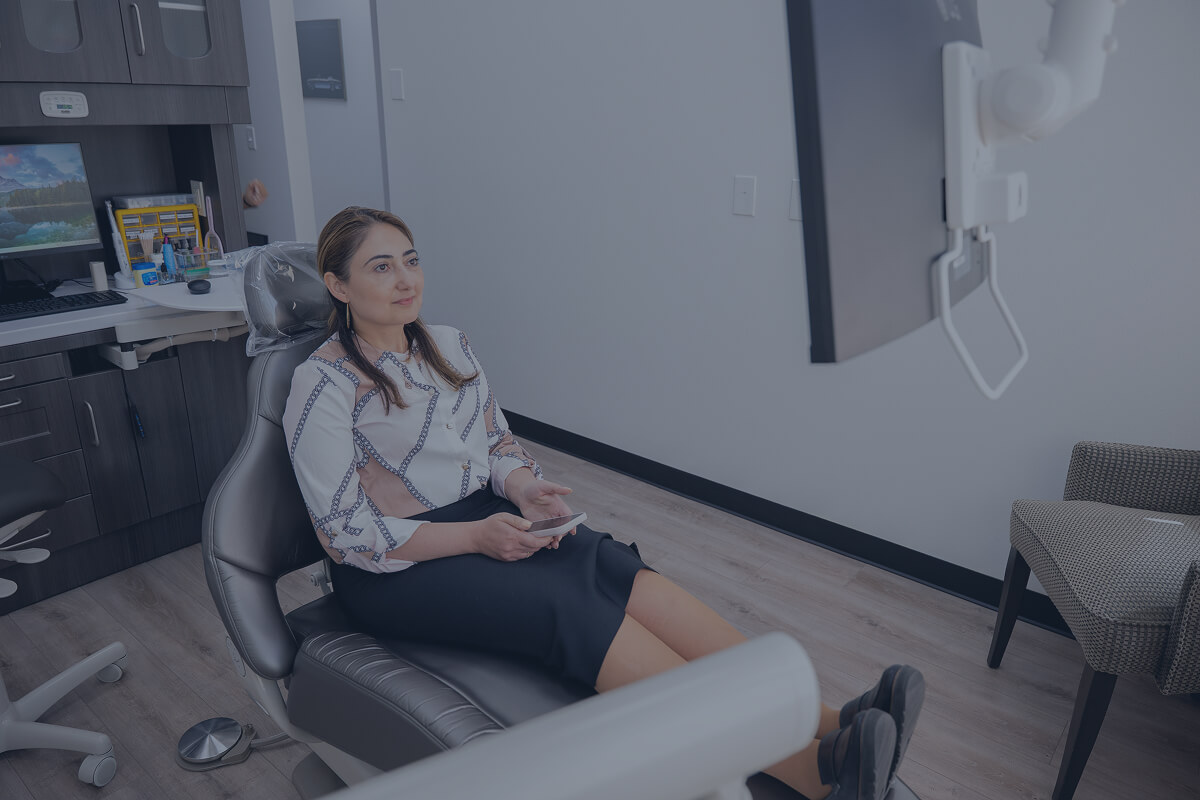 A middle aged patent at Diamond Dental Group discussing dental implant options in Denver CO.