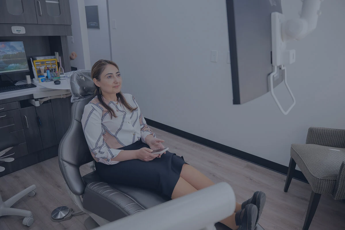 A middle aged patent at Diamond Dental Group discussing dental implant options in Denver CO.