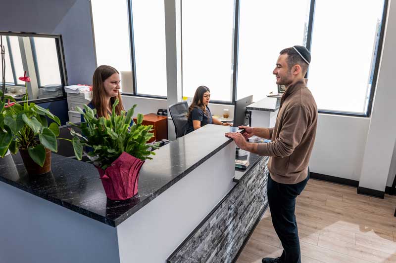 Image of a patient checking to the office of Diamond Dental Group in Denver CO. 