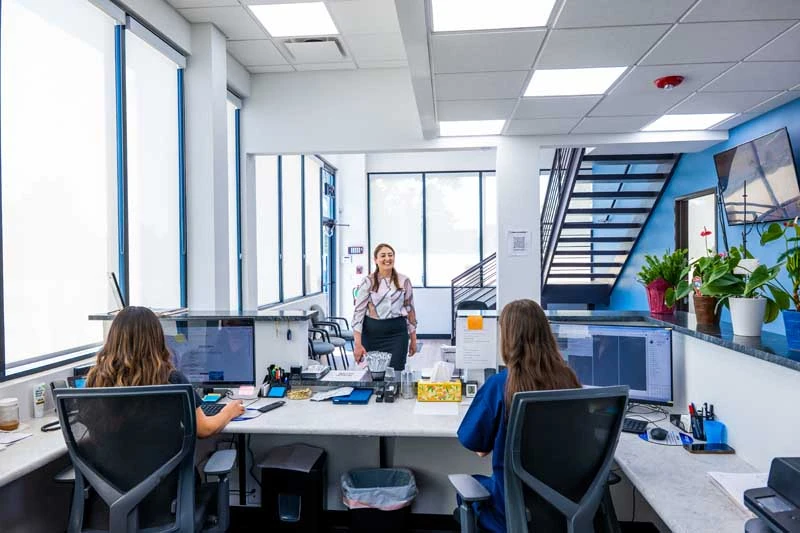 Patient applying for financing at the front desk of Diamond Dental Group in Denver CO.