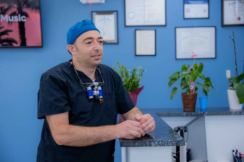 Dr. Alexander Katanov, DMD discussing with a patient at Diamond Dental Group.